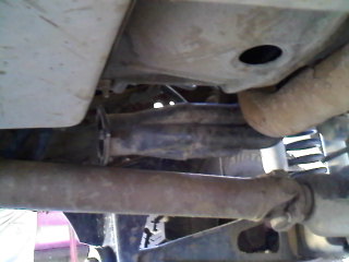 1995 Ford F-150 - Close-up of vehicle undercarriage, focusing on exhaust and drivetrain components.