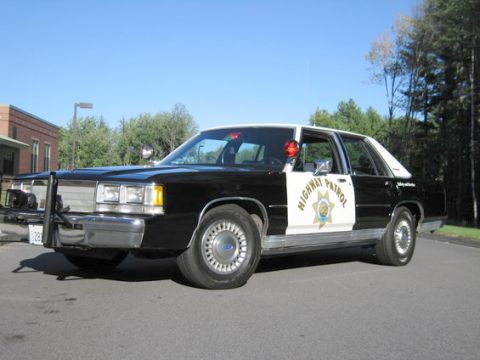1991 Ford LTD Crown Victoria - This 1991 Ford Crown Victoria is marked as a highway patrol vehicle and is shown from the front quarter angle.