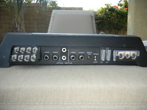1997 Ford Ranger - Rear view of a car amplifier showing various connection ports and fuse holders.