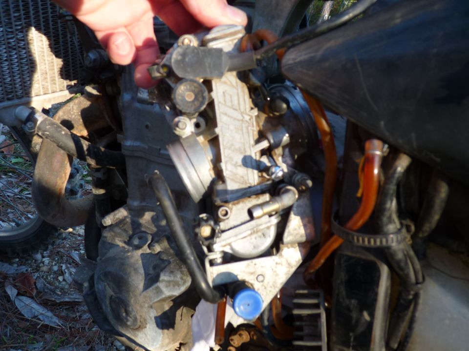 Motorcycle carburetor with fuel lines and engine components