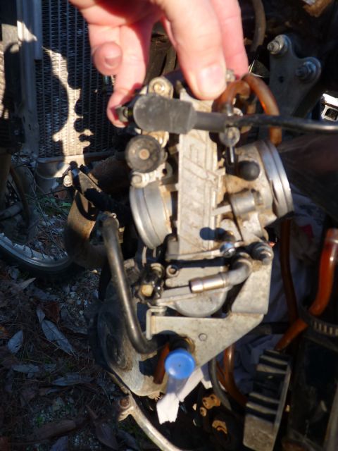 2001 Suzuki DR-Z400 - Close-up of a motorcycle carburetor, likely a Keihin FCR39, with attached hoses and cables.