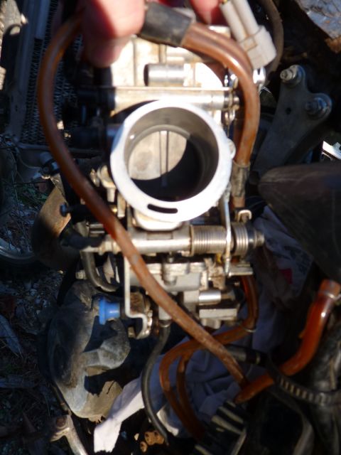 2001 Suzuki DR-Z400 - A detailed view of a motorcycle's carburetor assembly, showing various hoses and mechanical components.