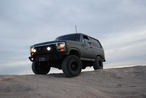 1982 Ford Bronco - This modified 1982 Ford Bronco is shown in a three-quarter front view, equipped with off-road tires and a winch.