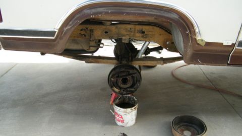1982 Ford Bronco - The rear axle and suspension components are exposed, with the brake drum removed for service.