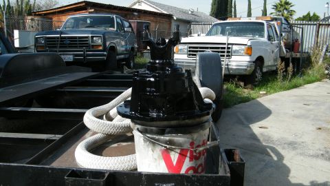1982 Ford Bronco - Differential part on trailer with vintage Ford Bronco and Ford truck visible.