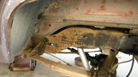 1982 Ford Bronco - Close-up of the vehicle's undercarriage, focusing on the frame and suspension components.