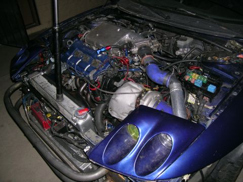 1995 Ford Probe - The engine bay shows a complex setup with a turbocharger and custom modifications.