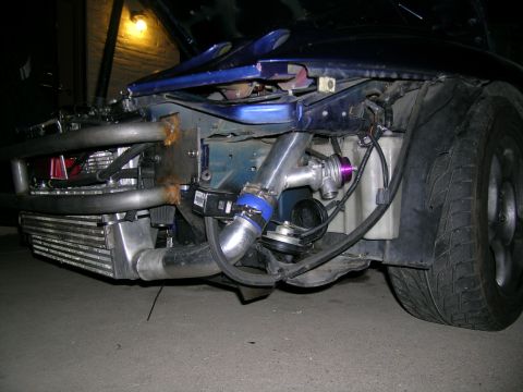 1995 Ford Probe - Custom turbo setup visible in the engine bay of a blue car.