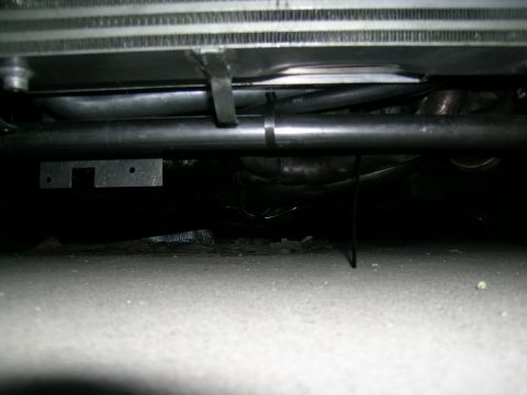 1995 Ford Probe - Close-up view of the underbody piping and radiator of a 1995 Ford Probe, likely part of a turbo build.
