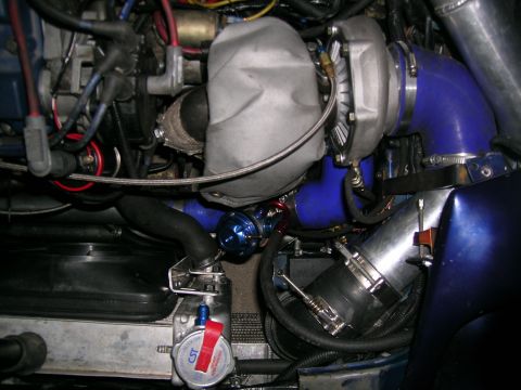 1995 Ford Probe - Engine bay detail showing turbocharger and associated plumbing, with some legible markings on a component.