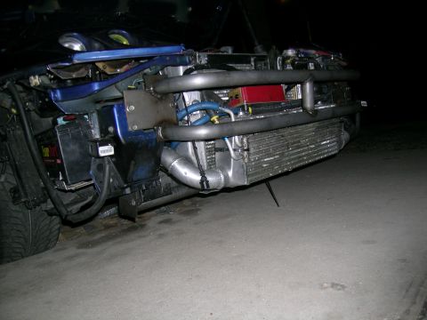 1995 Ford Probe - Customized car front end with aftermarket intercooler and piping visible.