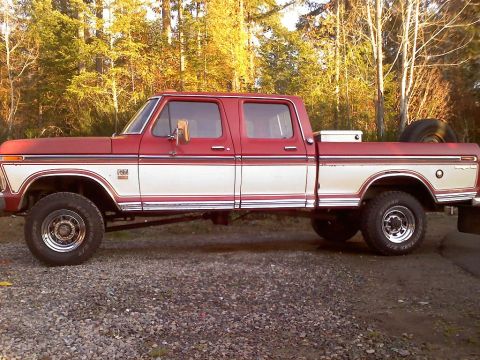 1977 Ford F-150 - This red and white 1977 Ford F-150 crew cab pickup truck is seen from the side.
