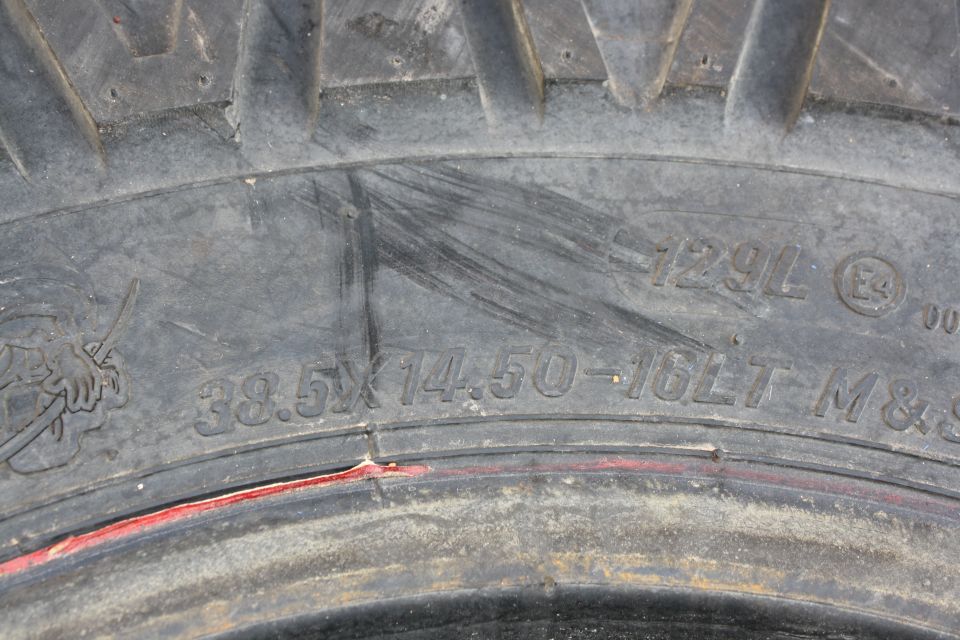 Close-up of tire sidewall showing size 38.5x14.50-16LT