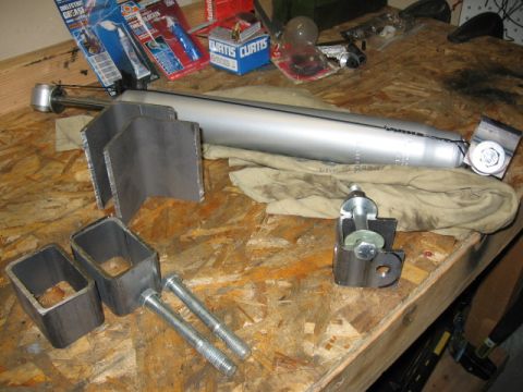 1995 Ford Bronco - Parts for a vehicle suspension system are laid out on a workbench.