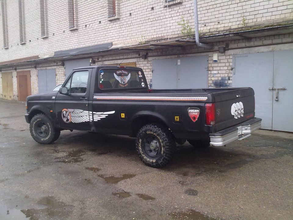 Black pickup truck with winged decals and Ducati Corse sticker