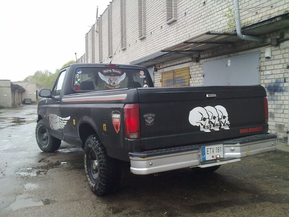 Black pickup truck with skull decals on the tailgate and wing decals on the side and rear window. License plate is ETV 181
