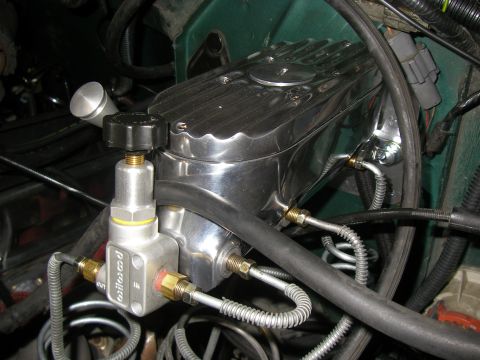 1990 Ford Bronco - Close-up of custom brake components, including a chrome master cylinder and a Wilwood proportioning valve.