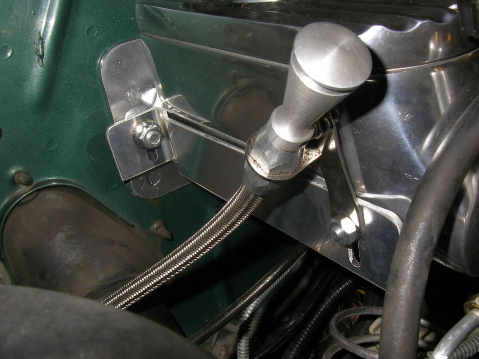 Custom aluminum lever on a master cylinder reservoir, with braided brake line