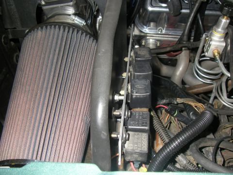 1990 Ford Bronco - Close-up view of engine components including an air filter and multiple Bosch relays.