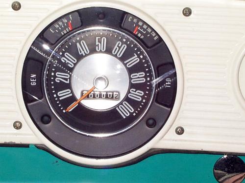 Vintage truck gauge cluster with 100-mph speedometer, odometer at 00002, fuel and temp gauges in white dash panel