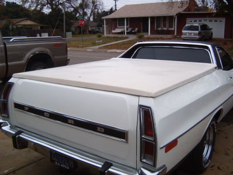 1973 Ford Ranchero - The rear of a white 1973 Ford Ranchero pickup is visible, parked next to another truck.