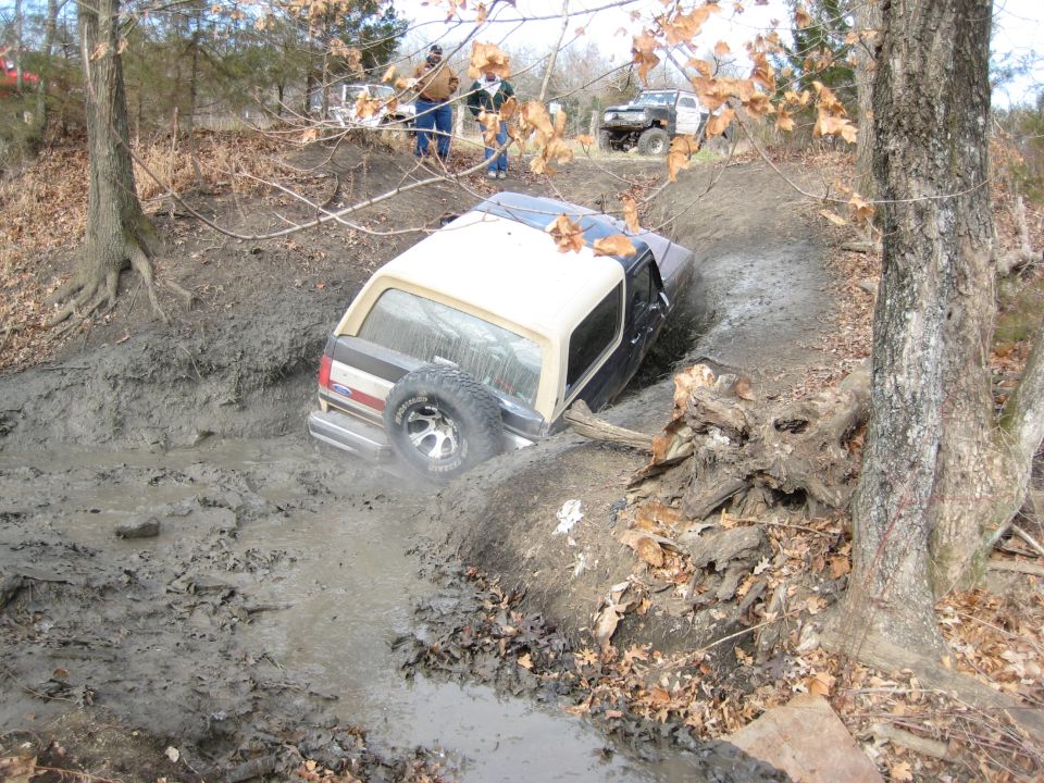 Off-road vehicle stuck in mud, side view