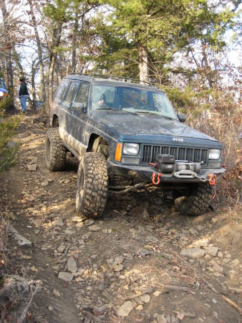 2005 Jeep Wrangler - This modified Jeep Cherokee XJ is shown off-roading on a steep, rocky incline.