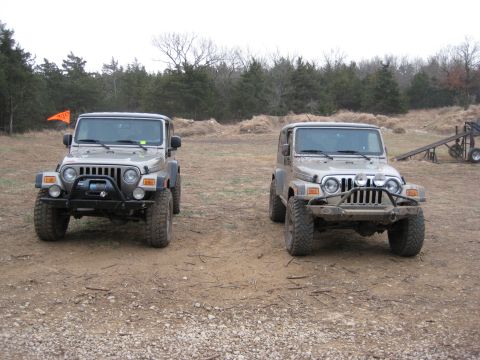 2005 Jeep Wrangler - Two Jeep Wranglers are parked side-by-side on a dirt lot.
