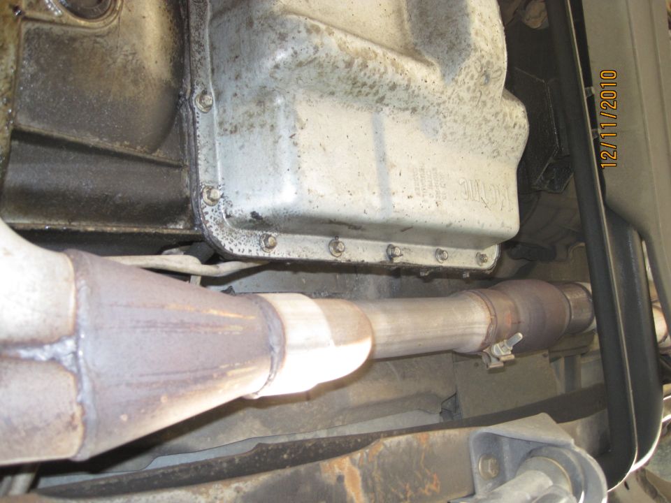 Underside view of vehicle exhaust pipes and catalytic converter