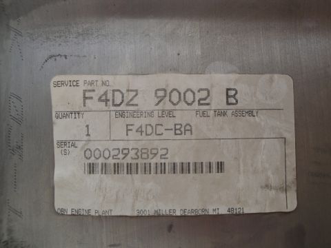 1995 Ford Taurus - A label on a fuel tank assembly indicates its part number, quantity, engineering level, and serial number.