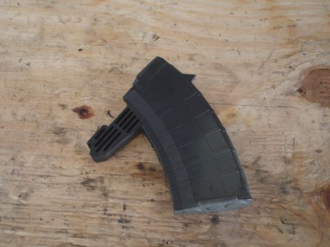 1989 Ford Bronco - A black rifle magazine is shown resting on a wooden surface, with "SUPERMOTORS.NET" visible in the lower right corner.