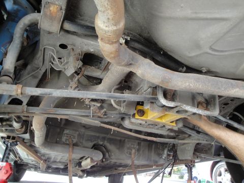 1995 Ford Taurus - Underside of a car, revealing exhaust system, fuel tank, and suspension components.
