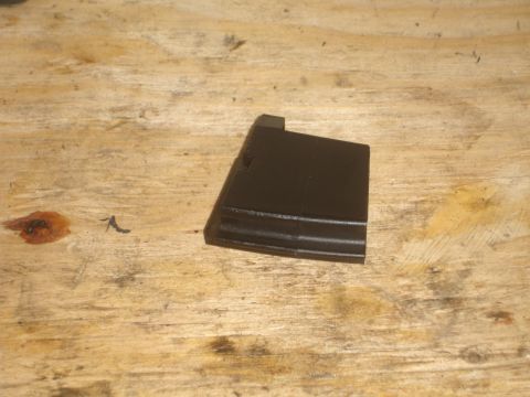 1989 Ford Bronco - A black plastic automotive trim piece is shown against a wooden background.
