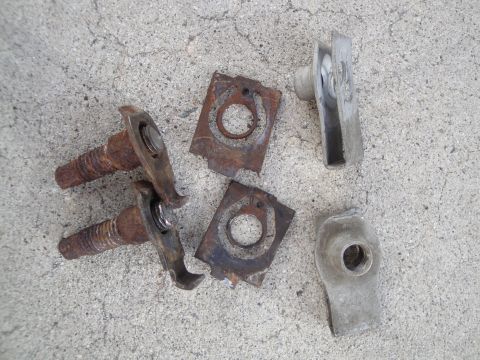 1995 Ford Taurus - Various automotive fasteners, including bolts and clips, lie on a concrete ground.