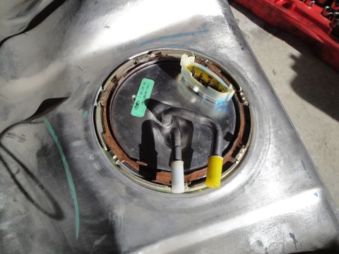 1995 Ford Taurus - A close-up view of a fuel pump assembly, showing the intricate parts and a Ford branded sticker.