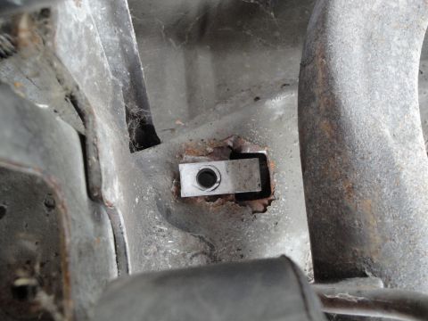 1995 Ford Taurus - Detail of a corroded metal component, showing signs of wear and tear.