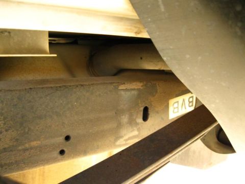 1996 Ford Bronco - Close-up view of the underside of a vehicle frame, showing a leaf spring and a sticker with the letters BVB.