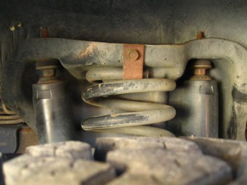 1996 Ford Bronco - This image shows the suspension system of a vehicle, focusing on the coil spring and shock absorber.