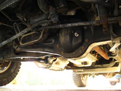 1996 Ford Bronco - The underside of a vehicle shows its mechanical components, including the differential and suspension system.