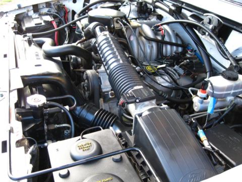 1996 Ford Bronco - Close-up view of a vehicle's engine bay, showing the air intake system and other engine components.