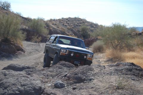 1982 Ford Bronco - This 1982 Ford Bronco is shown tackling a challenging off-road course in a dry, arid environment.