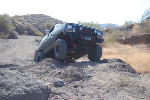 1982 Ford Bronco - This SUV is tackling a challenging rocky terrain on an outdoor trail.