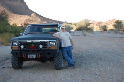 1982 Ford Bronco - Man poses with his modified 1982 Ford Bronco in a dry, desert environment.