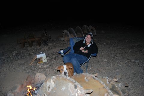 1982 Ford Bronco - Campfire scene with people, dogs, and large auger bits at night.
