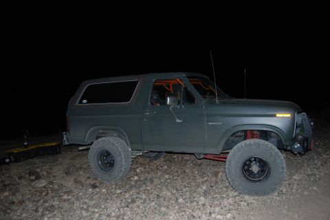 1982 Ford Bronco - This modified Ford Bronco is parked off-road at night, an interior roll cage and lifted suspension.