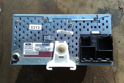1987 Ford Bronco - Rear view of a Ford car stereo part, showing connectors and part number 3L2T-18C668-BC.