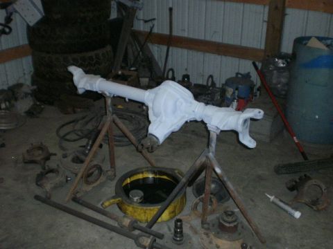 1995 Ford Bronco - A differential axle assembly is prepared for work in a cluttered garage setting.