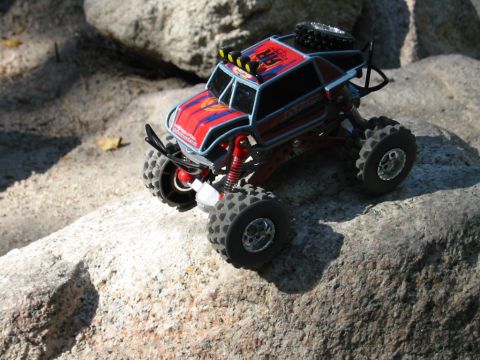 1985 Ford Bronco - This remote control rock crawler toy is positioned on a rocky surface.