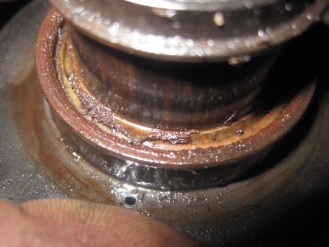 2003 Ford Ranger - Close-up view of a damaged bearing seal, showing signs of wear and contamination.