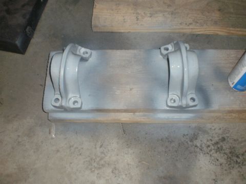 1995 Ford Bronco - Two metal brackets painted gray and mounted on a wooden plank.